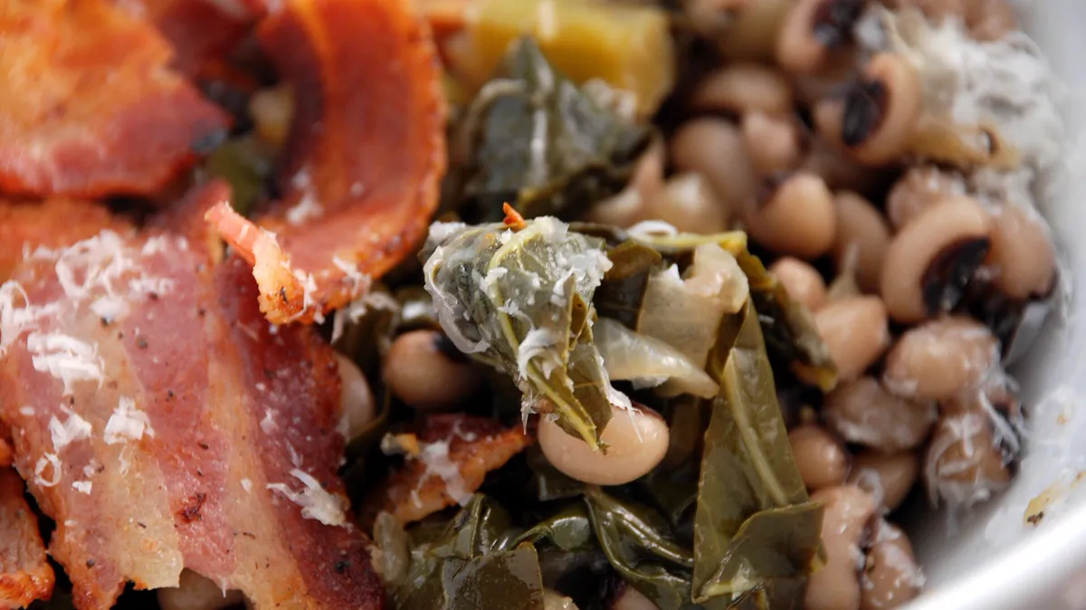Black-eyed peas, collards and bacon in a good luck bowl Bowl of black-eyed peas with braised collard greens and crisp bacon, the Southern lucky meal for January 1